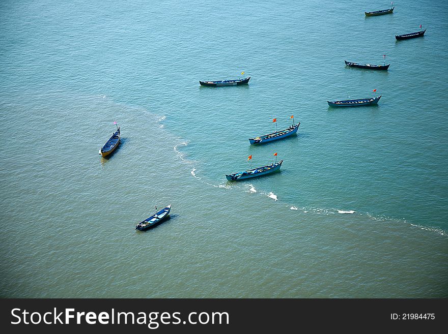 Group of small boats anchored in the blue waters of Arabian sea. murudeshwar Karnataka India. Group of small boats anchored in the blue waters of Arabian sea. murudeshwar Karnataka India