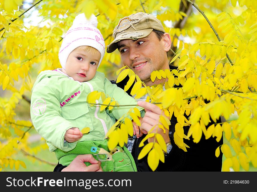 Small beautiful girl in green suit with father