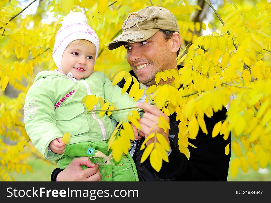 Small beautiful girl in green suit with father