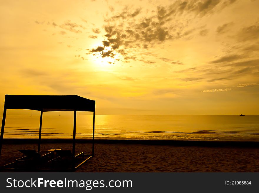 Beach beds and tent at colorful dawn at Hua Hin beach, Thailand