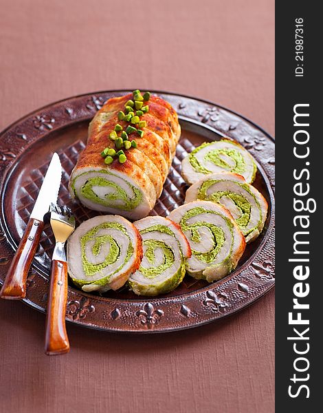 Roasted pork roulade with pistachio on plate