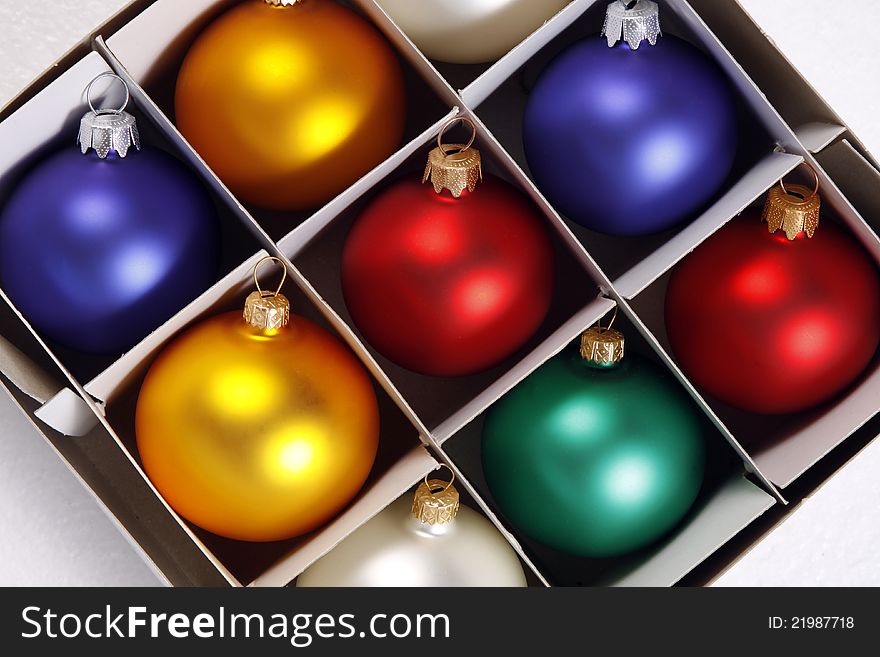 Colorful baubles in the white box. Colorful baubles in the white box