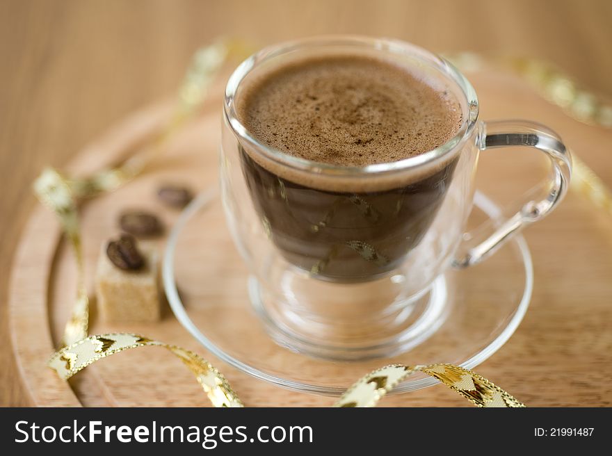 Cup of coffee, sugar, coffee beans on a wooden background