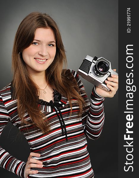 Pretty woman taking photo with vintage camera