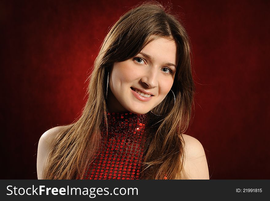 Portrait of the beautiful woman on a red background