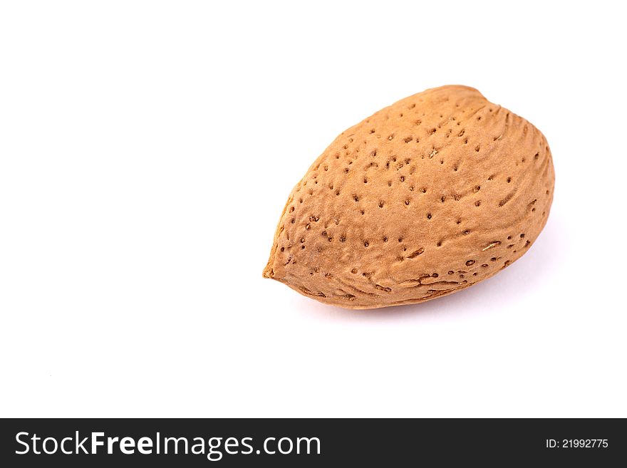 One almond nut in macro isolated over white. One almond nut in macro isolated over white