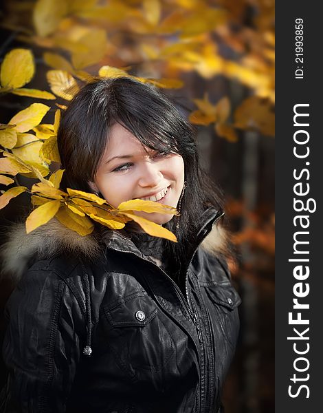 Happy young woman in autumn forest