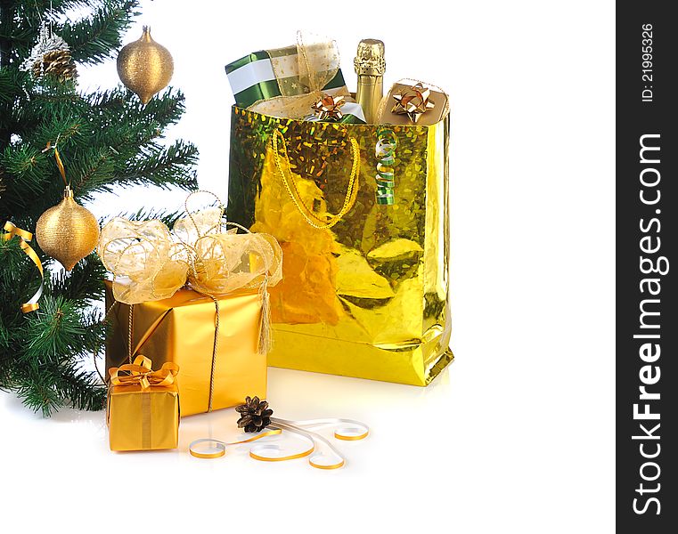 Decorated golden gift boxes under Christmas tree on white background. Decorated golden gift boxes under Christmas tree on white background