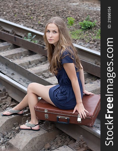 Woman sitting on rails outdoors shooting