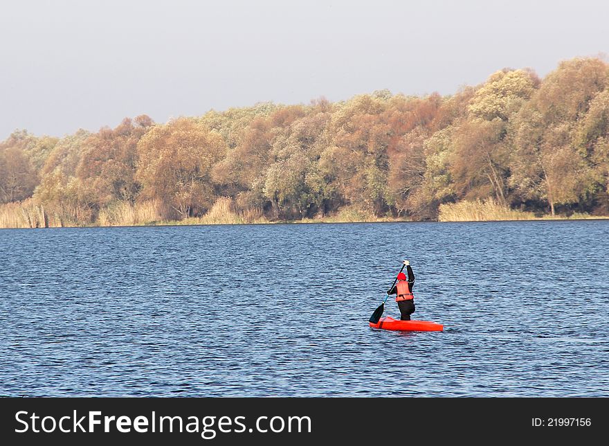 Sportsman in a red canoe. Fall