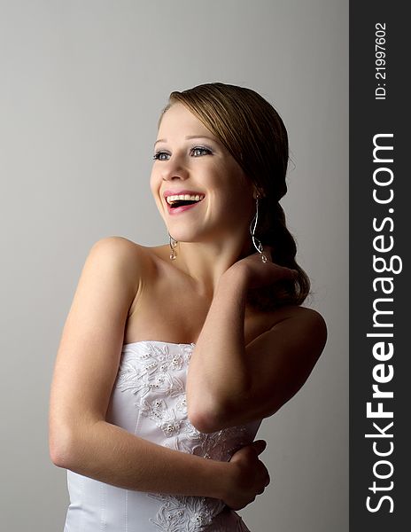 Beautiful young woman in evening dress laughs. Beautiful young woman in evening dress laughs