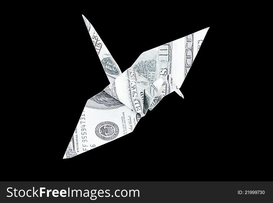 Financial Freedom Concept. Top view of the Origami bird made from the dollar banknote with isolated on black background