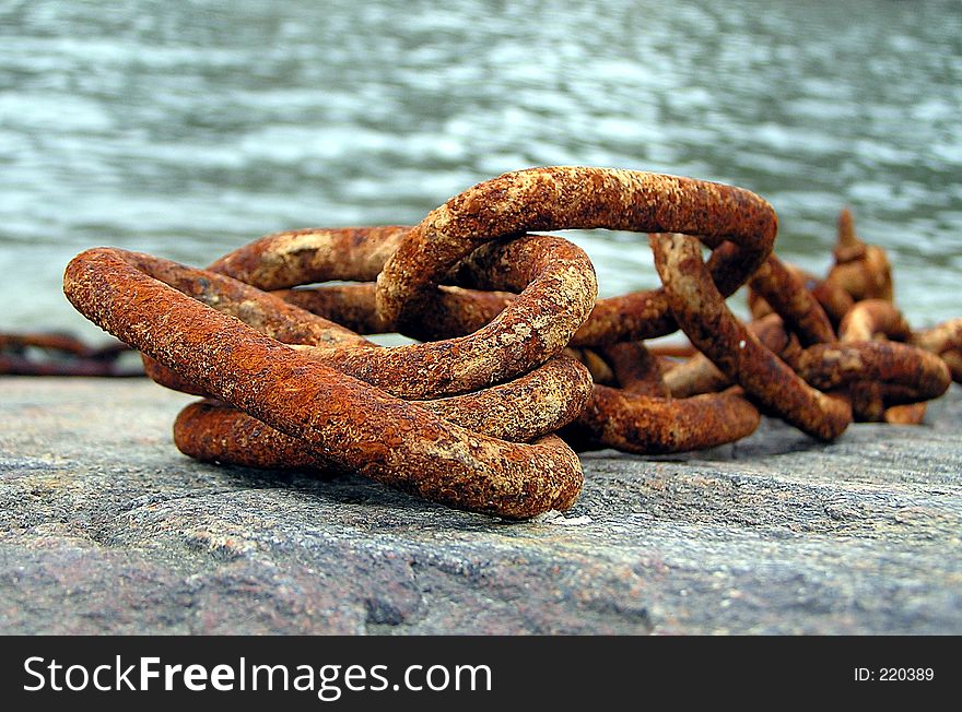 A rusty chain in the harbor