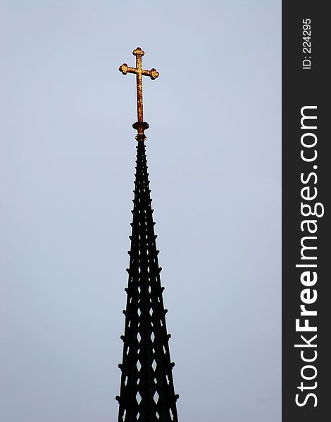 A Cross high up on a Church.