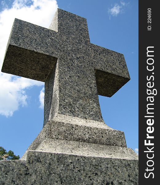 Cross on a gravestone in a cemetery