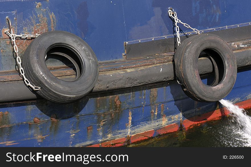Tires tied to the side of a tugboat