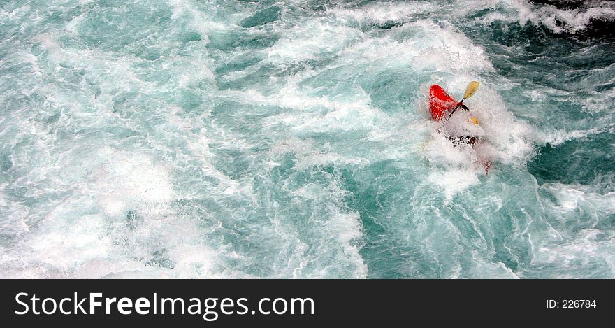 A kayaker in a class 5 rapid