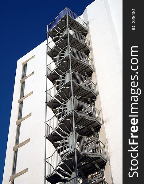 Fire escape stairs on a whit wall