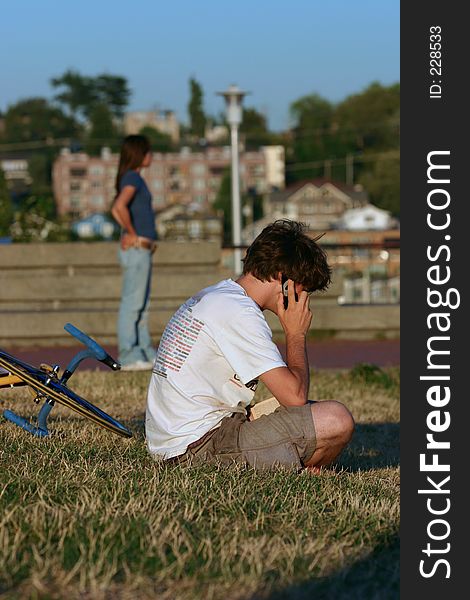 A young man on the phone enjoying the feeling of closeness a cell phone can offer. A young man on the phone enjoying the feeling of closeness a cell phone can offer