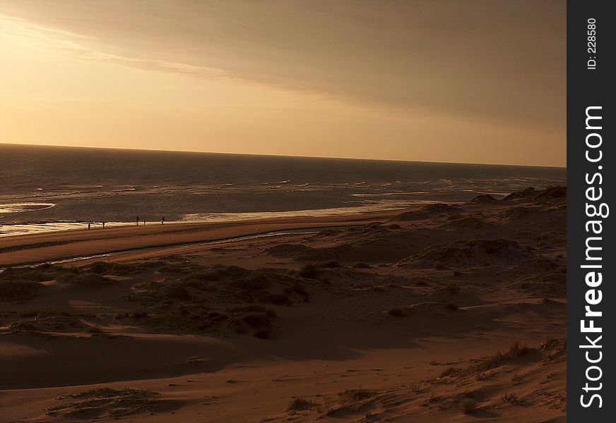 The sun goes down off the beach, and a mist softens the view. The sun goes down off the beach, and a mist softens the view.