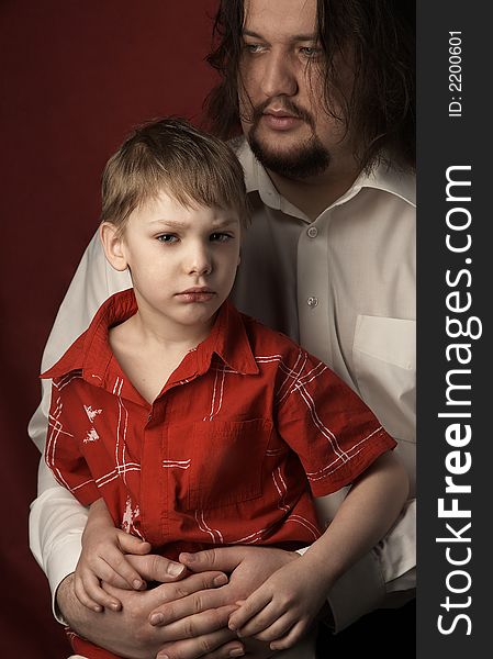 Father and son, portrait on red background