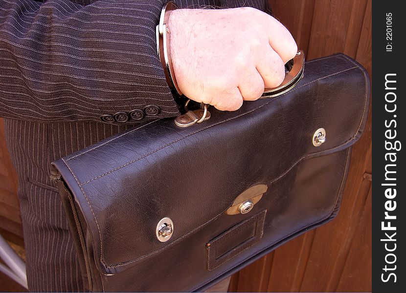 Businessman carrying his leather brief case securely