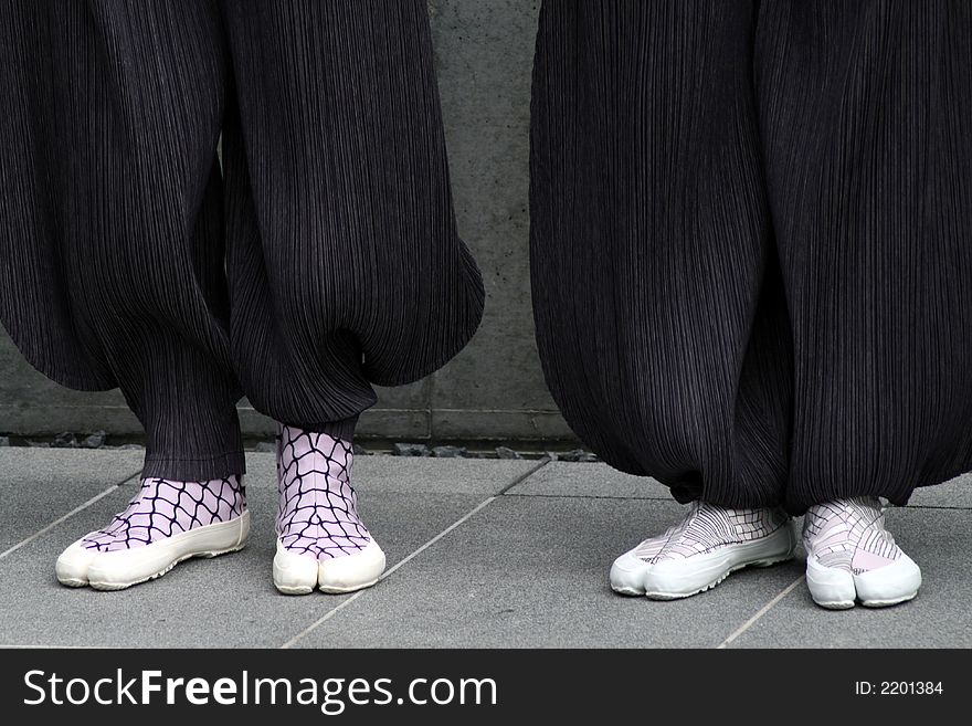 Two persons with funny shoes and wide trousers. Two persons with funny shoes and wide trousers.
