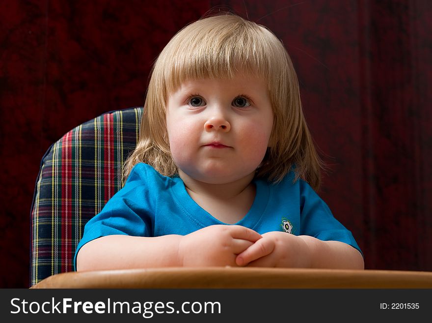 Portrait of cute little girl sitting and listening something