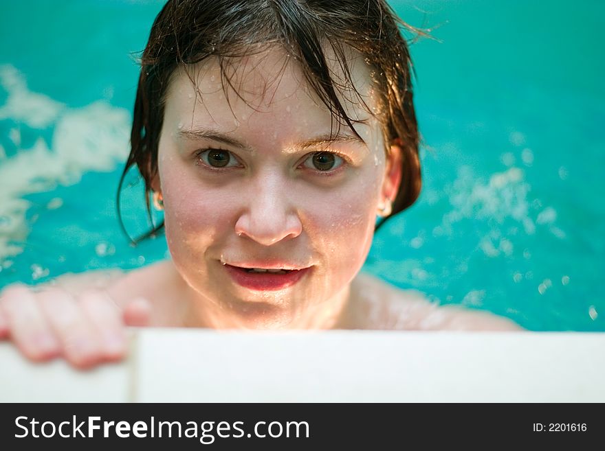 Lively bright portrait of young woman at the swimming pool