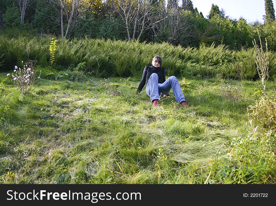 Young woman relaxes on the grass