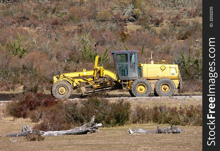 Bulldozer working in a mountain road in the Andes