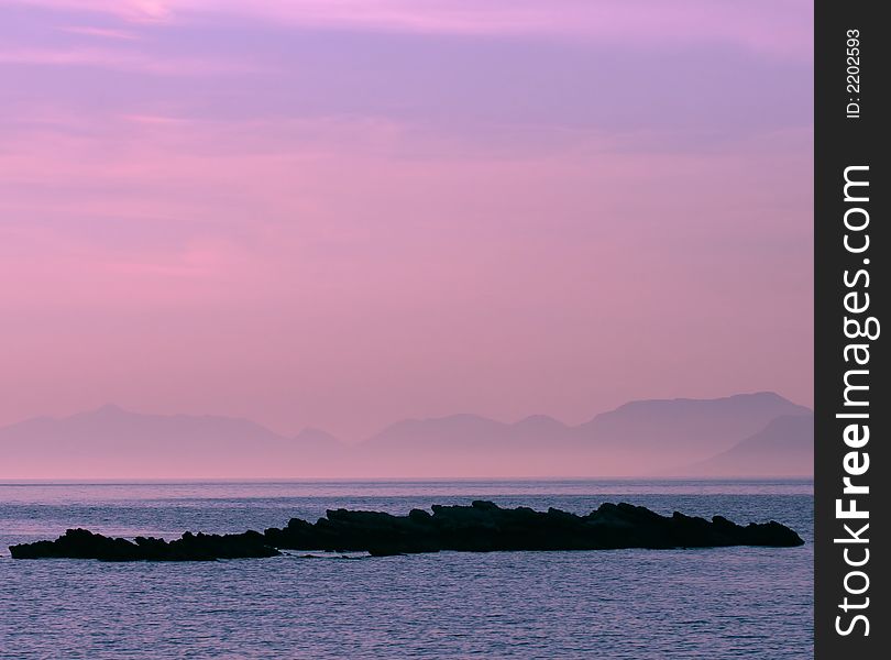 Small island on the sea while sunset