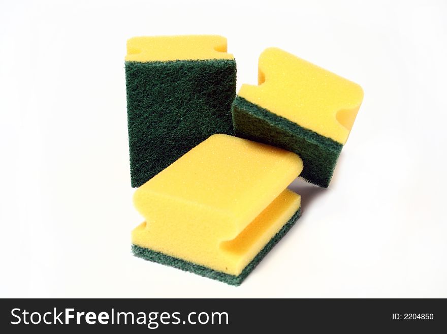 Three yellow scourers isolated on a white background. Three yellow scourers isolated on a white background.