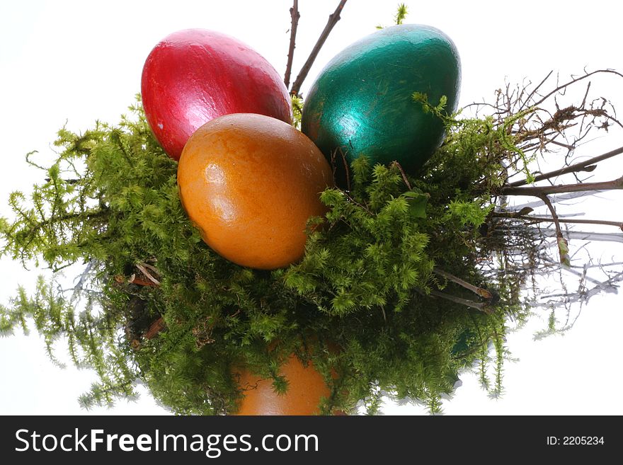 Coloured easter eggs in a jack from a moss and branches. Coloured easter eggs in a jack from a moss and branches
