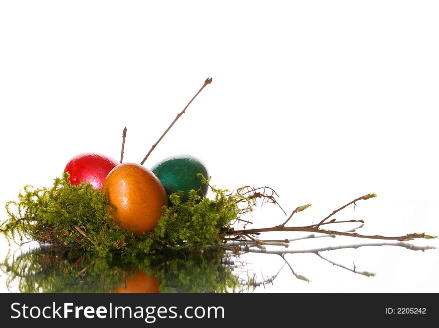 Coloured easter eggs in a jack from a moss and branches. Coloured easter eggs in a jack from a moss and branches