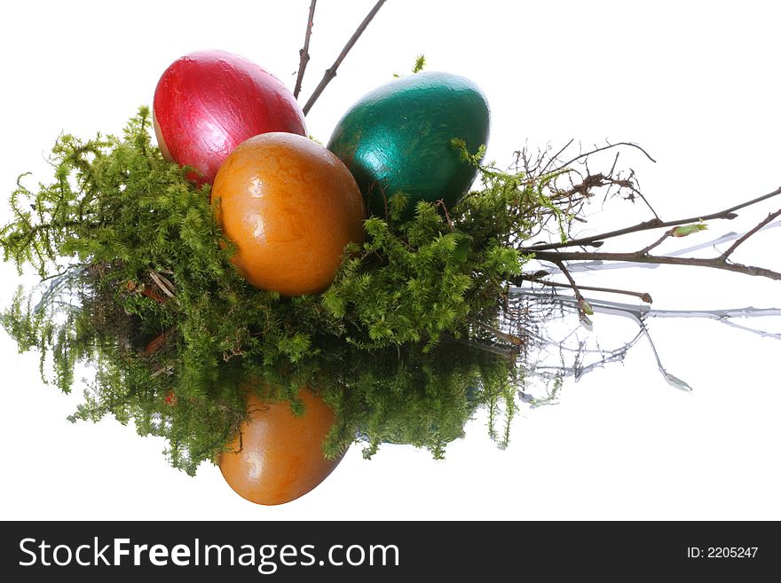 Coloured easter eggs in a jack from a moss and branches. Coloured easter eggs in a jack from a moss and branches