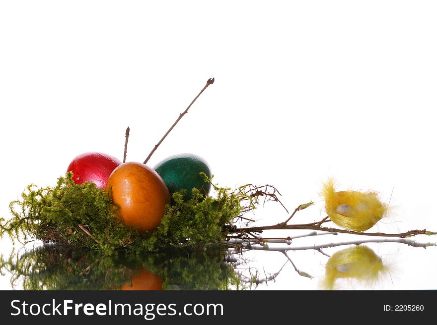 Coloured easter eggs in a jack from a moss and branches. Coloured easter eggs in a jack from a moss and branches