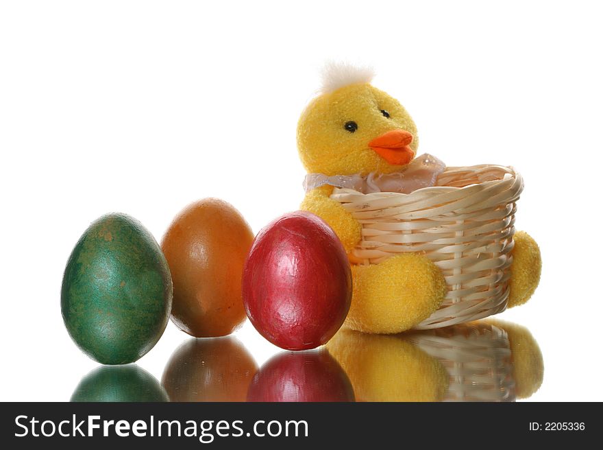 Colored easter eggs in a duck basket