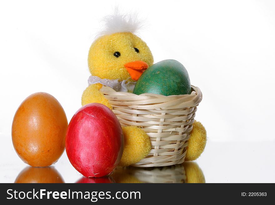 Coloured easter eggs in a duck basket. Coloured easter eggs in a duck basket