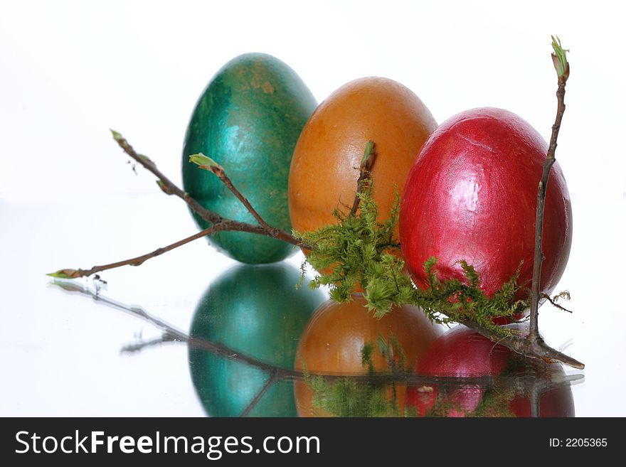 Colored easter eggs in a jack from a moss and branches