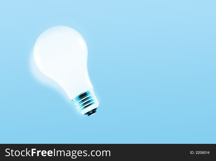 Glowing light bulb on a light blue background