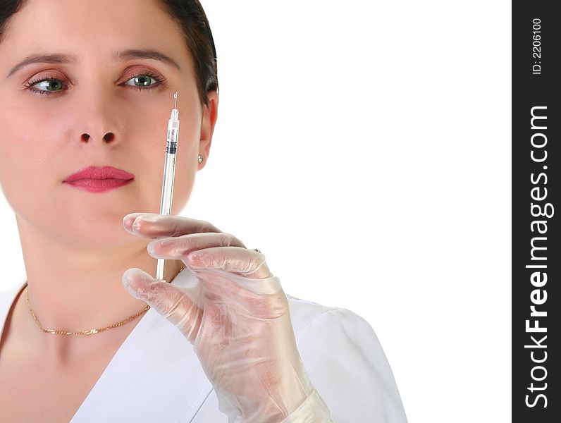 Female nurse getting ready for injection, focus on green eyes. Female nurse getting ready for injection, focus on green eyes