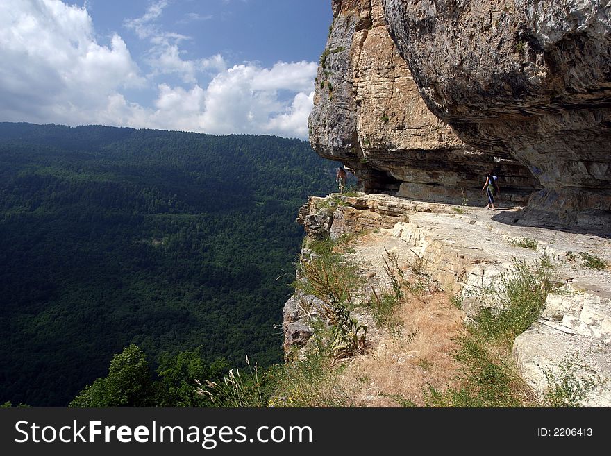 Mountain track above breakage between clouds and the ground