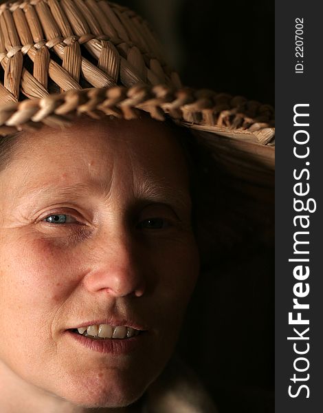 Woman in straw hat. Close-up of face