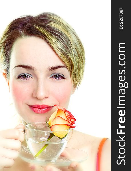 Smiling girl with rose in the cup