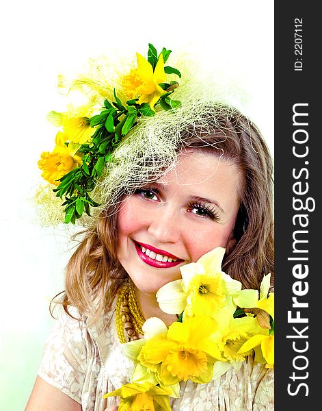 Beautiful smiling girl with narcissus in her hair