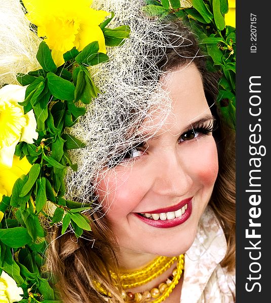 Beautiful smiling girl with narcissus in her hair