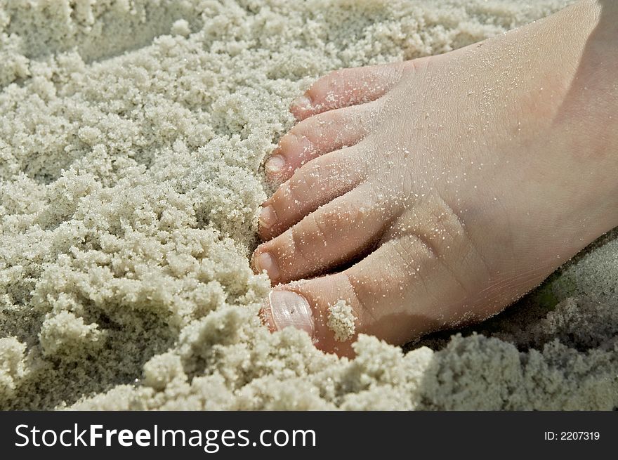 Kids foot in sandy beach fun
