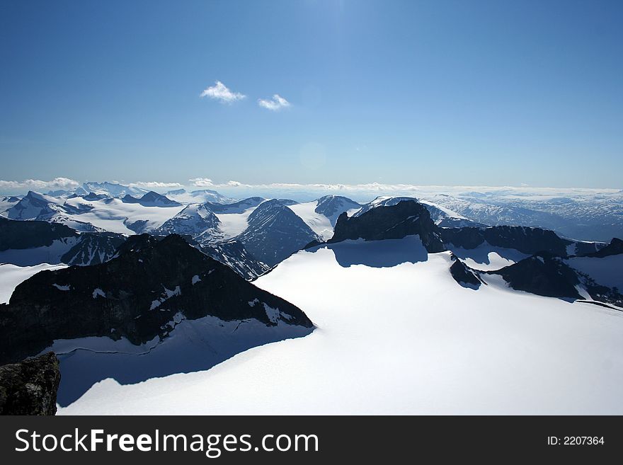 This is an image taken on the top of Galdhoepiggen 2469 meters above sealevel. This is the highest mountain in Northern Europe. The Glacier in the front is called Svellnosbreen. This is an image taken on the top of Galdhoepiggen 2469 meters above sealevel. This is the highest mountain in Northern Europe. The Glacier in the front is called Svellnosbreen.