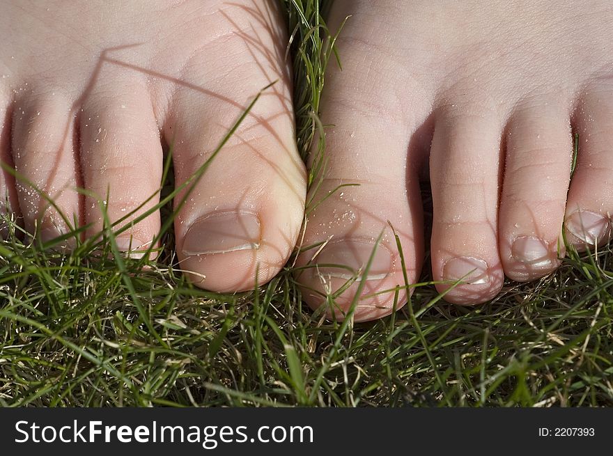 Child walking barefoot in grass